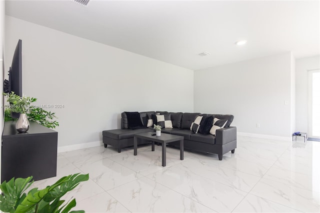 living area featuring recessed lighting, visible vents, marble finish floor, and baseboards