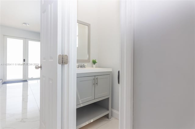 bathroom featuring french doors and vanity