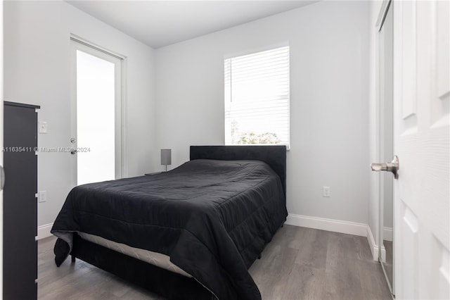 bedroom featuring baseboards and wood finished floors