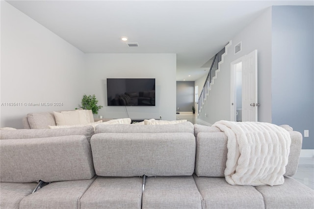 living room featuring recessed lighting, visible vents, and stairway