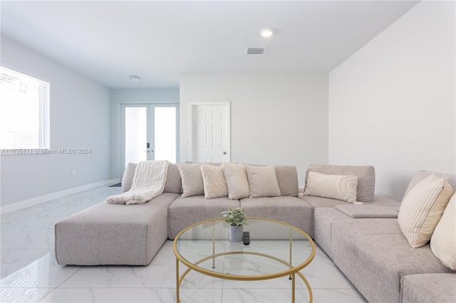 living area with french doors, visible vents, marble finish floor, and baseboards