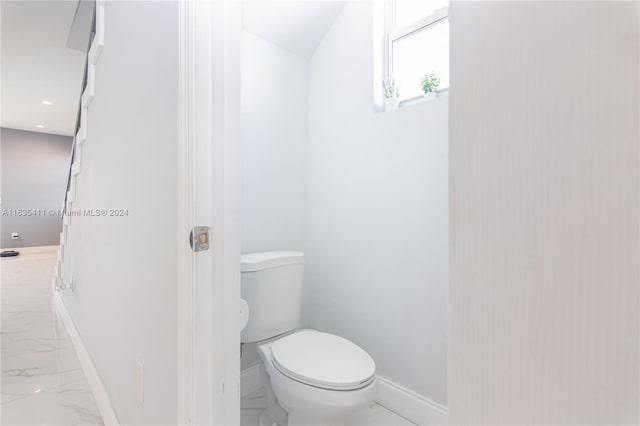 bathroom featuring recessed lighting, toilet, baseboards, and marble finish floor