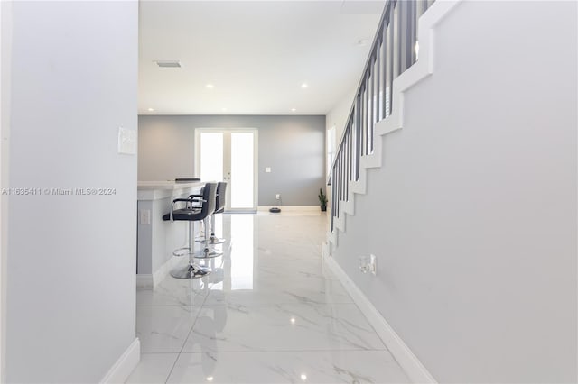 corridor with recessed lighting, baseboards, and marble finish floor