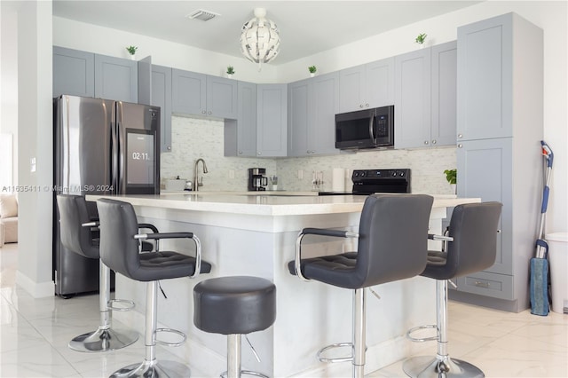 kitchen with visible vents, backsplash, light countertops, electric range, and marble finish floor