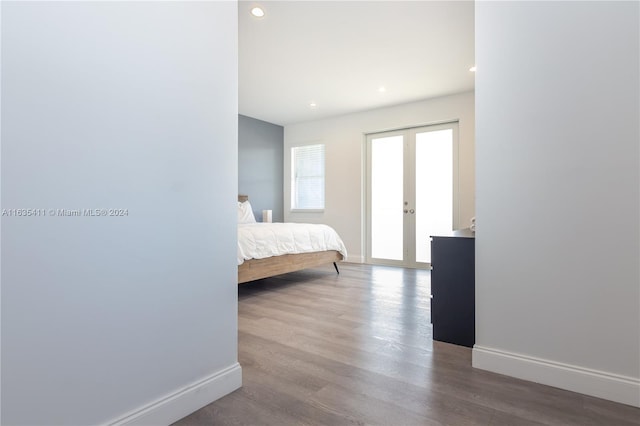 bedroom featuring recessed lighting, french doors, baseboards, and wood finished floors