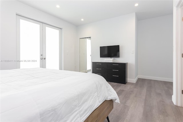 bedroom with access to exterior, baseboards, light wood-type flooring, recessed lighting, and french doors