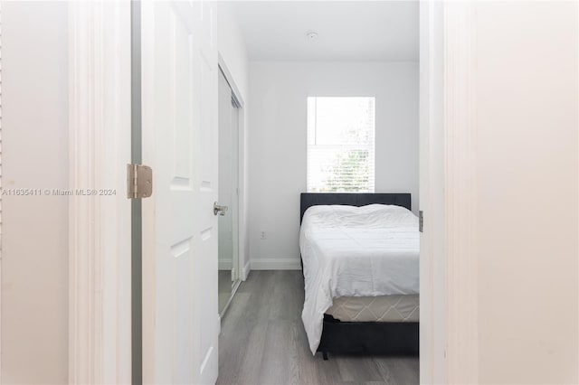 bedroom featuring baseboards and wood finished floors