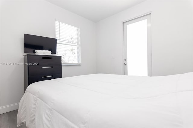 bedroom featuring baseboards and wood finished floors