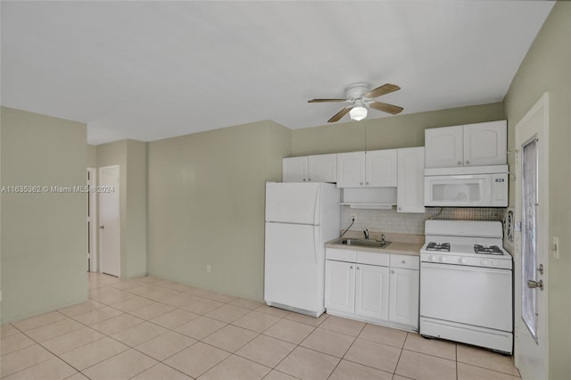 kitchen featuring white appliances, light tile patterned floors, white cabinetry, ceiling fan, and decorative backsplash