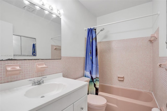 full bathroom with toilet, shower / tub combo with curtain, tile walls, vanity, and decorative backsplash