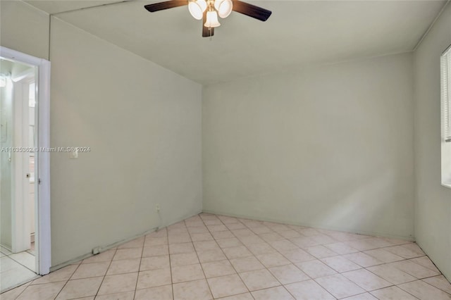 unfurnished room with ceiling fan and light tile patterned floors