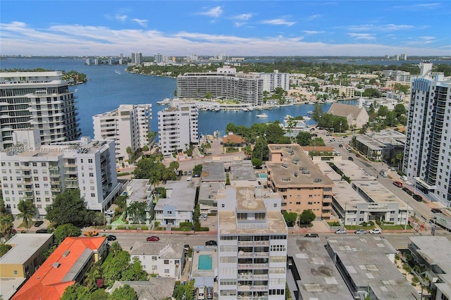 birds eye view of property with a view of city and a water view