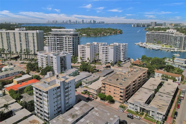 birds eye view of property with a water view and a city view