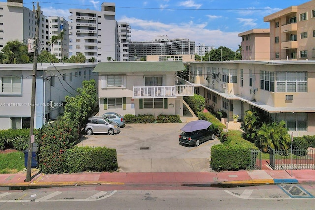 view of property featuring uncovered parking and a city view