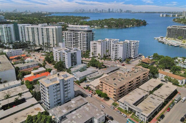 drone / aerial view featuring a water view and a view of city