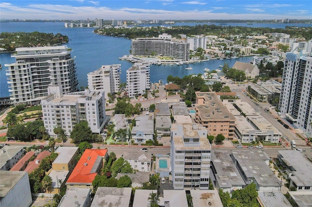 birds eye view of property featuring a view of city and a water view