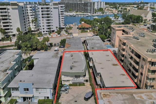 birds eye view of property with a water view and a city view