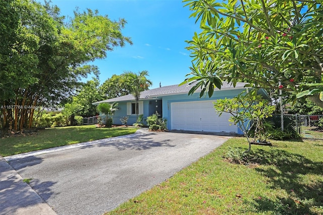 single story home featuring a garage and a front lawn