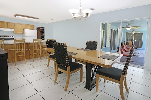 tiled dining space featuring ceiling fan with notable chandelier