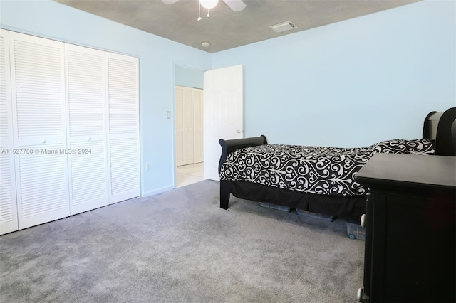 bedroom with carpet floors, a closet, and ceiling fan