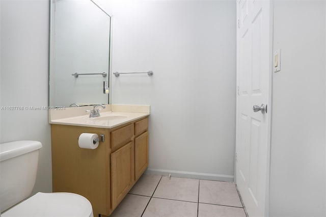 bathroom with tile patterned flooring, vanity, and toilet