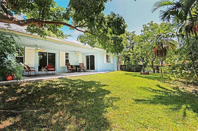 view of yard featuring ceiling fan and a patio