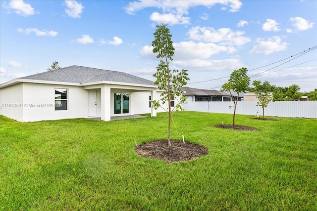 rear view of house featuring a lawn