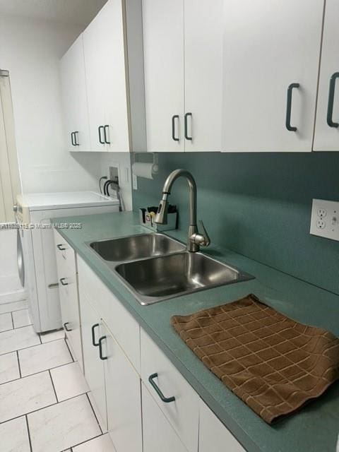 kitchen with white cabinetry, sink, and light tile patterned floors