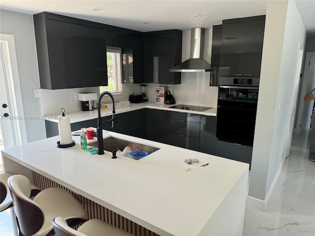 kitchen featuring light tile patterned floors, a center island, black appliances, wall chimney exhaust hood, and sink