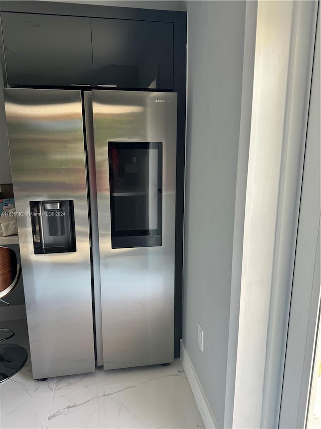 interior details with light tile patterned floors and stainless steel refrigerator with ice dispenser