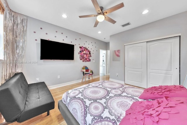 bedroom with a closet, ceiling fan, and wood-type flooring