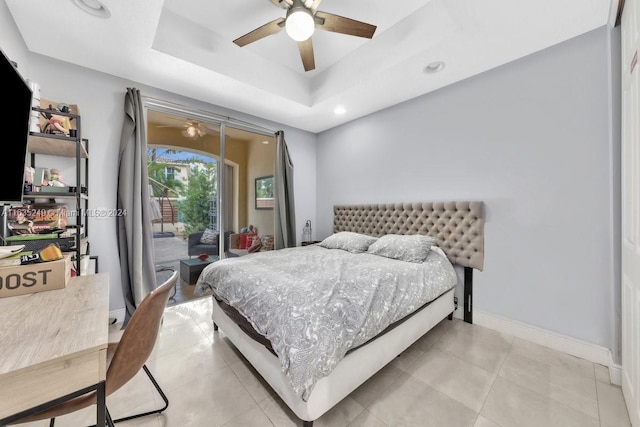 tiled bedroom featuring a raised ceiling, ceiling fan, and access to outside