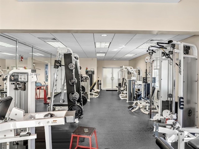 exercise room with a paneled ceiling