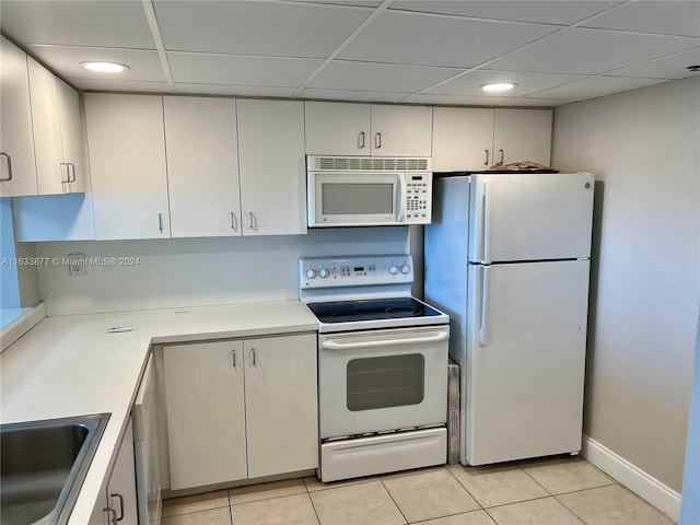 kitchen featuring white cabinets, white appliances, sink, and a paneled ceiling