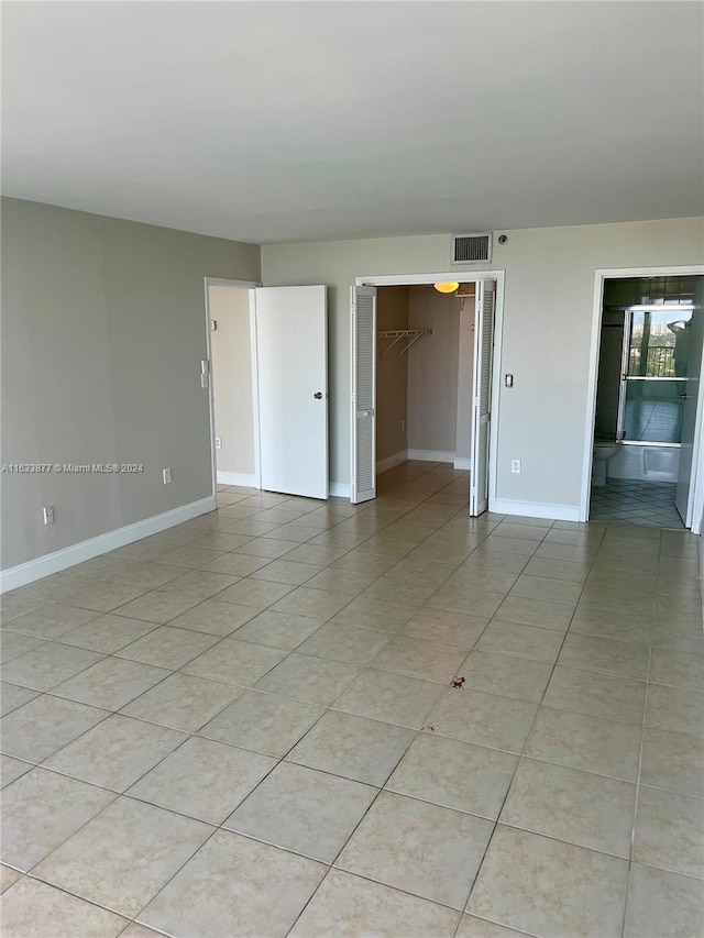 empty room with light tile patterned floors