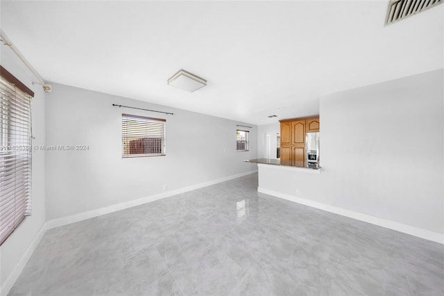 unfurnished living room with a wealth of natural light