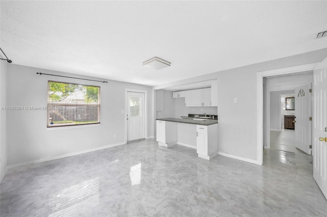 unfurnished living room with a textured ceiling