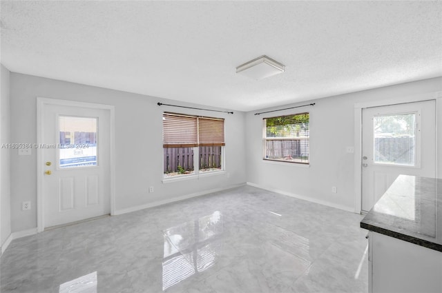 spare room featuring a textured ceiling