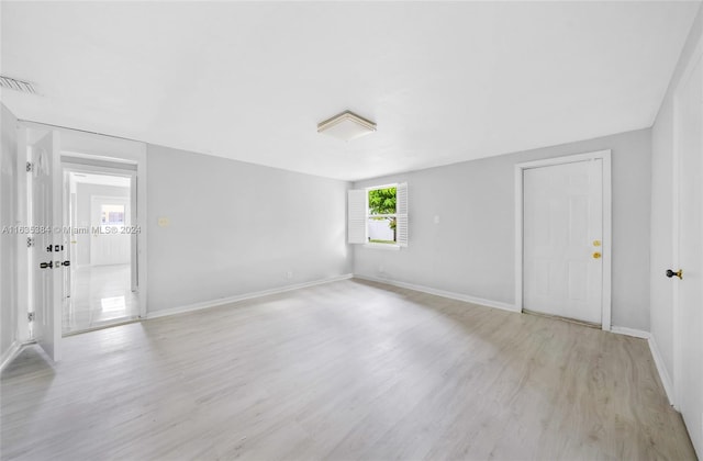 empty room with light hardwood / wood-style floors