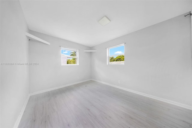 unfurnished room featuring light hardwood / wood-style flooring and plenty of natural light