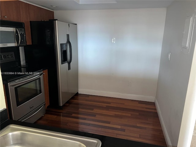 kitchen featuring appliances with stainless steel finishes and dark hardwood / wood-style floors