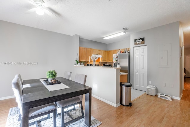 dining area featuring light wood-type flooring and ceiling fan