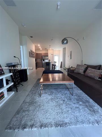 living room with tile patterned floors