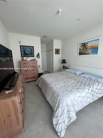 tiled bedroom featuring a closet