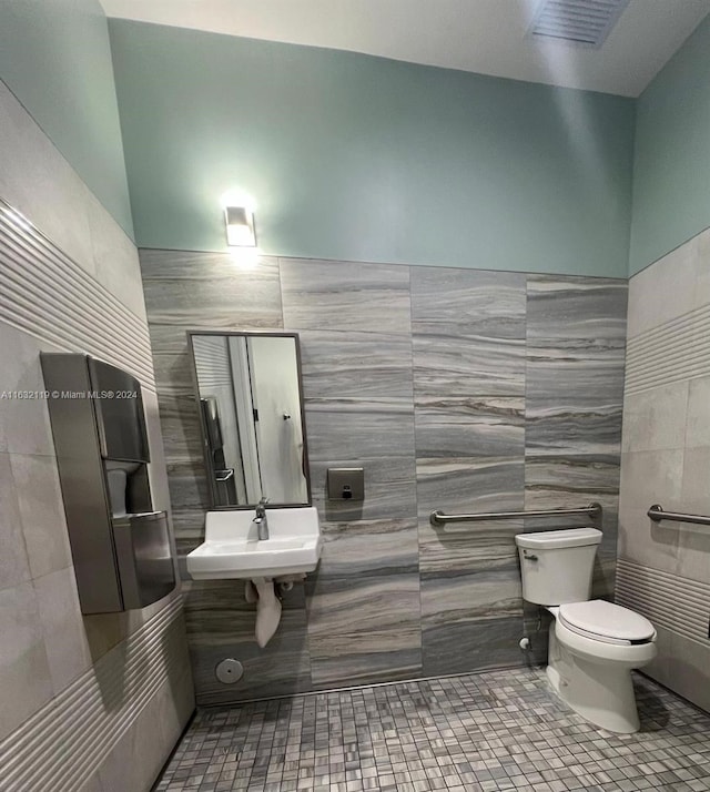 bathroom featuring sink, tile walls, toilet, and tile patterned flooring