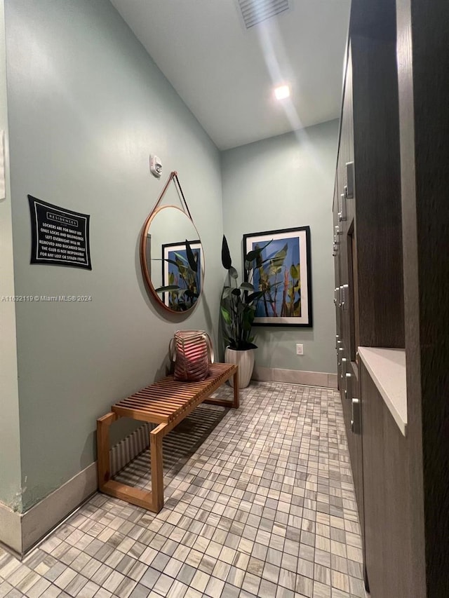 hall featuring light tile patterned flooring