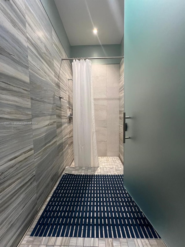 bathroom with tile patterned flooring and a shower with curtain