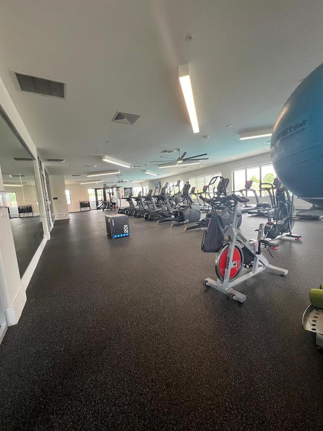 exercise room with ceiling fan