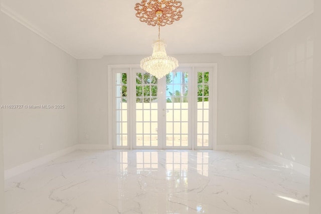 spare room with a chandelier and french doors