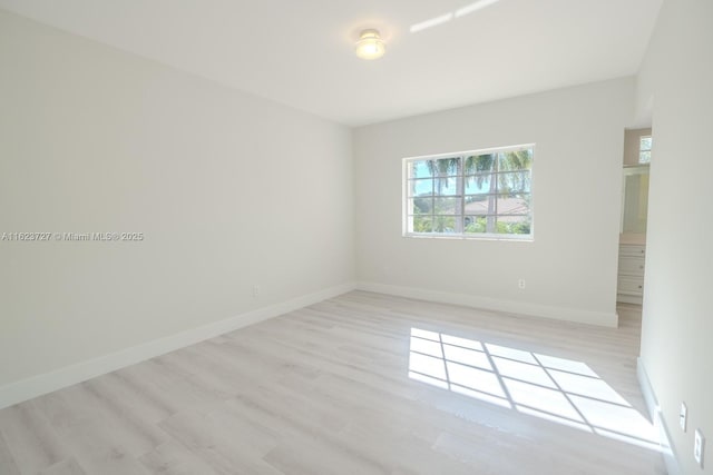 empty room with light hardwood / wood-style floors